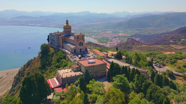 Aerial drone view of the Sanctuary of Tindari in Sicily, overlooking the stunning Mediterranean coast and lagoons. A breathtaking blend of history, faith, and Sicilian landscape from above.
