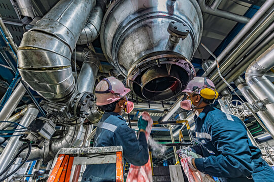 Male worker inspection weld tank, penetrant tank chemical grease