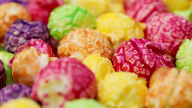 Bright colorful fruit caramel popcorn circle rotation close up