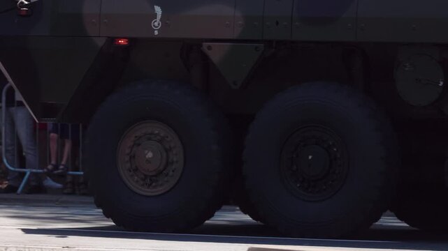 Wheels of armored tanks driving on city streets during a military parade