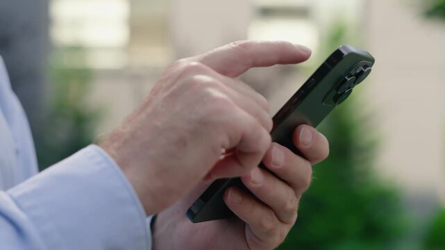 Close up unknown man male hands holding smartphone in city formal unrecognizable businessman using mobile phone business chat app scrolling screen display online service user internet outdoor daylight