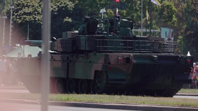 Military parade. Army vehicles marching down the streets. The KTO Rosomak is a family of eight-wheeled armored fighting vehicles derived from the Finnish Patria AMV.