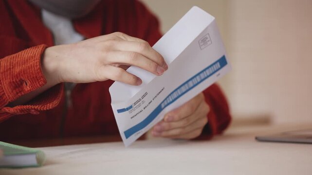 Male in cervical neck collar reading a hospital bill letter, high medical cost