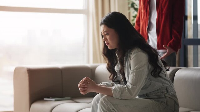 Desperate Korean woman listening to boyfriend's accusations, relationship crisis