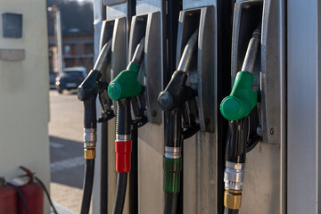 Fuel Pump Nozzles at Gas Station. Close-up of multiple fuel pump nozzles at a gas station, showing gasoline and diesel refueling equipment, energy supply, and transportation service. © Iryna