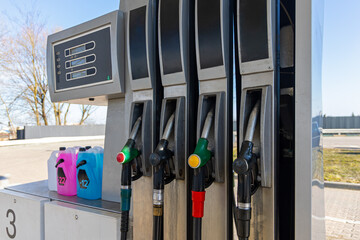 Gas Station Fuel Pumps and Display. Front view of a gas station pump with multiple fuel nozzles and digital display, showing refueling equipment, energy service, and transportation infrastructure. © Iryna