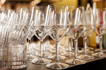 Rows of Empty Wine and Water Glasses for Banquet Service