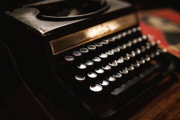 Close-up of a vintage manual typewriter on a wooden desk