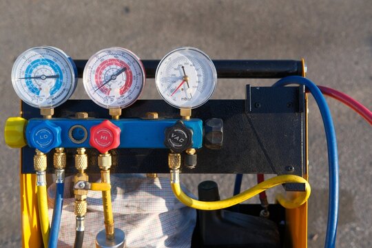 4-way manifold gauge set outdoors ready for using, pressure gauge. Maintenance and repair of refrigeration and air conditioning or HVAC system. Industrial equipment for measuring