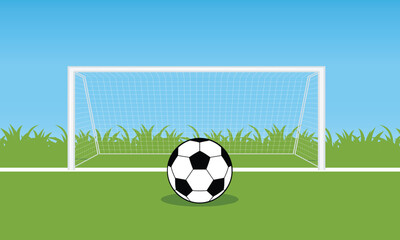 Soccer ball in front of goal on green field with clear blue sky