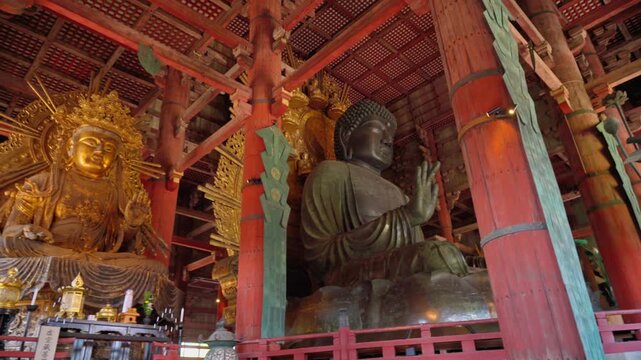 Nara, Japan - Sep 26 2024, Panoramic view of the Sitting Buddha Vairochana, a fifteen-meter bronze statue of Buddha, and a side-standing gilded statue of Buddha, at Todaiji Temple, Nara, Japan