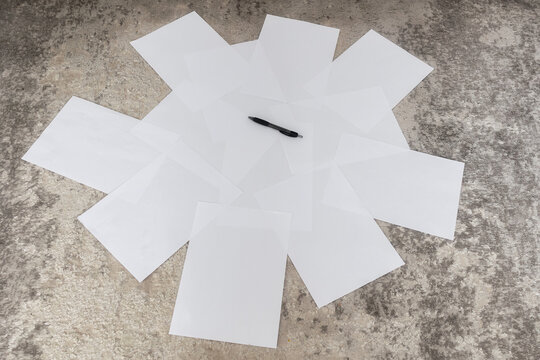 Scattered A4 Papers and Pencil on Carpet With Grunge Wall Texture