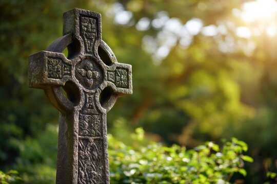 Close-up mossy celtic cross gravestone ornate stone carving bathed in warm sunlight in a green cemetery