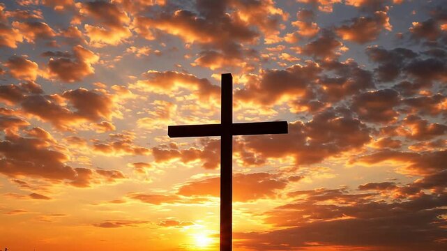 Silhouette of a cross against sunset sky