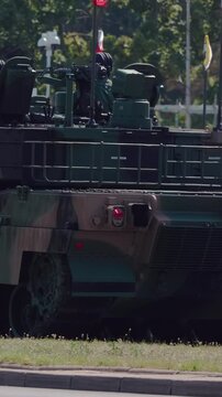 Military parade. Army vehicles marching down the streets. The KTO Rosomak is a family of eight-wheeled armored fighting vehicles derived from the Finnish Patria AMV.