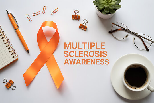 Minimalist top view of a grey table with an orange ribbon highlighting multiple sclerosis awareness