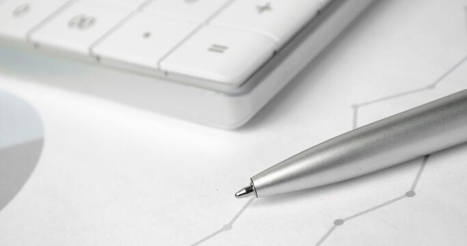 accounting concept pen calculator financial statement on accountant's desk