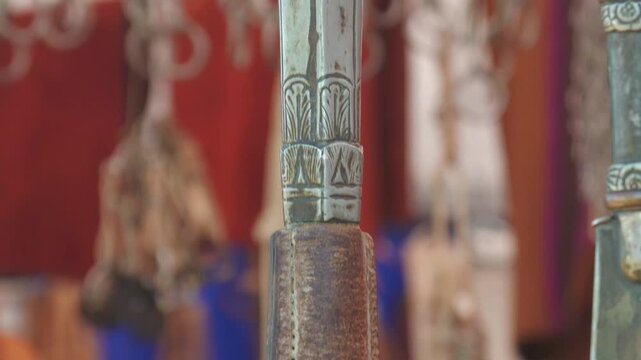 
Traditional Argentine gaucho whip with hand-crafted metal and cowhide leather strap for sale at a popular market
