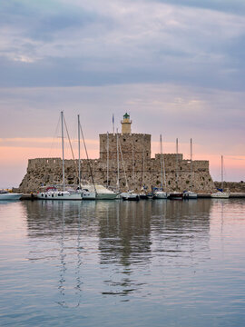 Saint Nicholas Fortress and Mandraki Marina at sunrise, Medieval Old Town, Rhodes City, Rhodes Island, Dodecanese, Greece