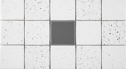 Grid of white speckled tiles with one plain dark grey center tile, close-up texture