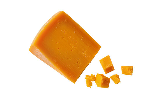 Delicious vibrant orange cheddar cheese wedge and scattered cubes, isolated PNG on transparent background, ideal for culinary designs