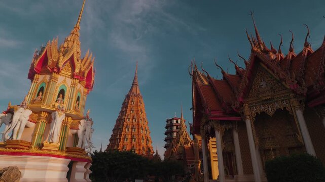 Detailed view of ornate golden Buddhist architecture at Wat Tham Suea, also known as Tiger Cave Temple, a famous hilltop temple complex in Kanchanaburi, Thailand.