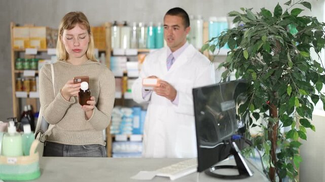 Young woman uses modern payment methods using a mobile and QR code. Customer scans the barcode to read the detailed information on the pharmacy's website. High quality 4k footage