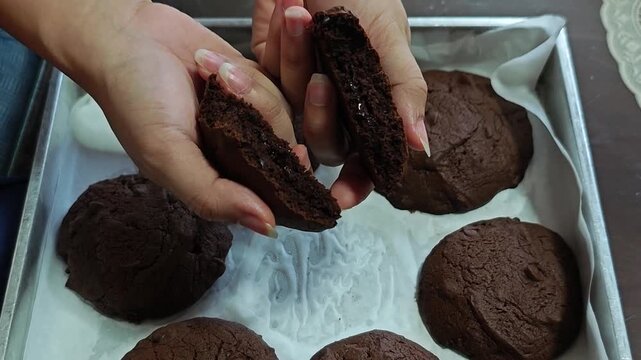  chocolate  cookie broken in half in hands