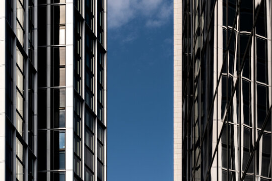Urban modern facade in Frankfurt Germany with vertical lines and contrast against sky highlighting architecture detail pattern and highrise building form