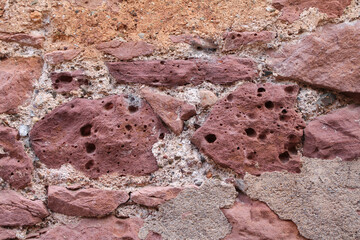 Fototapeta premium Red Natural Stone Wall Texture – Rustic Architecture Background