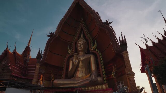 Golden Buddha statue at Wat Tham Suea, also known as Tiger Cave Temple, a famous Buddhist temple complex in Kanchanaburi, Thailand, known for its hilltop views and ornate architecture.