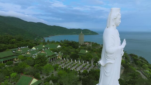 Aerial View of the Lady Buddha Statue and Linh Ung Pagoda in Da Nang, Vietnam
reveals the majestic white statue overlooking the ocean and the city of Da Nang, Vietnam