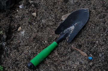 a garden trowel, commonly used for digging small holes and turning soil.