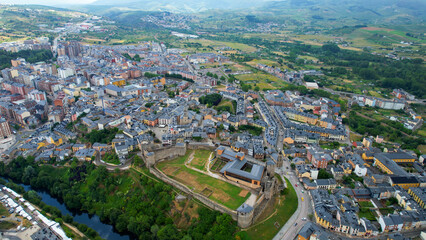 Fototapeta premium Aerial panoramic view of the city Ponferrada in Spain on a cloudy summer noon.