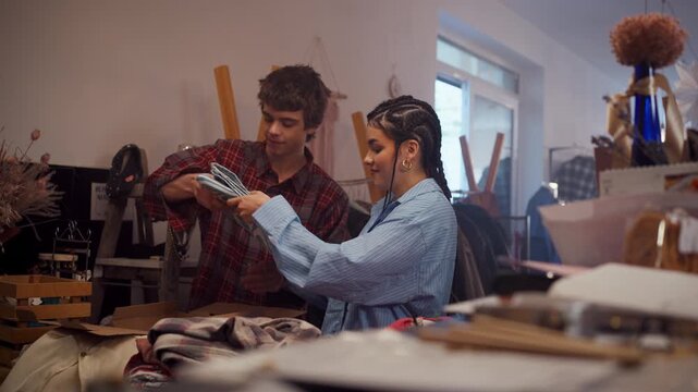 Volunteers sorting donated clothes for charity drive in community donation center