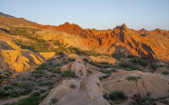 Red rocks, canyon of eroded sandstone formations, red and orange sandstone rocks, fairytale gorge, Skazka, Tosor, Kyrgyzstan