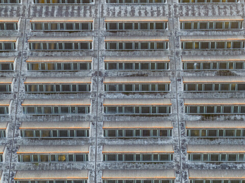 Aerial view of the building's facade, a symphony of geometric patterns and muted tones, creating a visually captivating composition, Rome, Lazio, Italy.