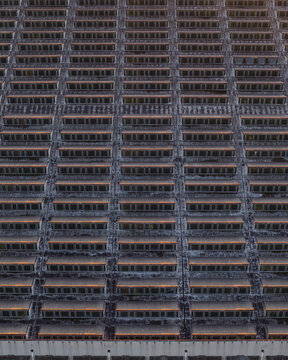 Aerial view of a repetitive yet intricate pattern of balconies creates a captivating urban texture, showcasing the architectural density, Rome, Lazio, Italy.