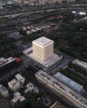Aerial view of the Palazzo della Civilt&Atilde;&nbsp; Italiana, its stark white facade contrasting against the muted greens of surrounding trees, Rome, Lazio, Italy.