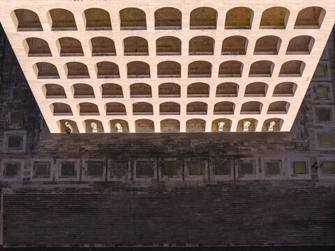 Aerial view of the Palazzo della Civilt&Atilde;&nbsp; Italiana stands in stark white against the verdant trees and the soft hues of the dawn sky, Rome, Lazio, Italy.