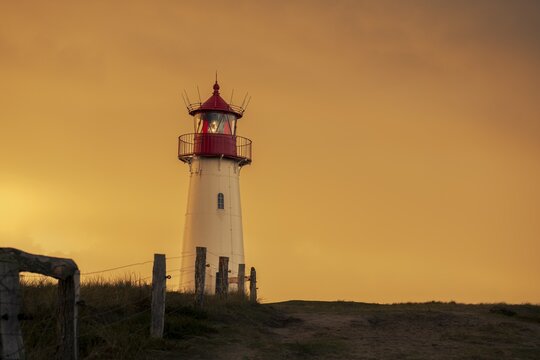 List-ost lighthouse, in dune landscape at golden hour, Ellenbogen, List, Sylt Island, Germany