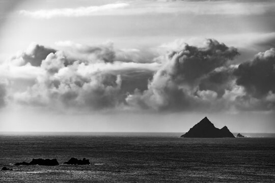 North Atlantic with the mountain peaks of the Skelligs in the background and dramatic cloudy sky, Killarny, County Kerry, Ireland