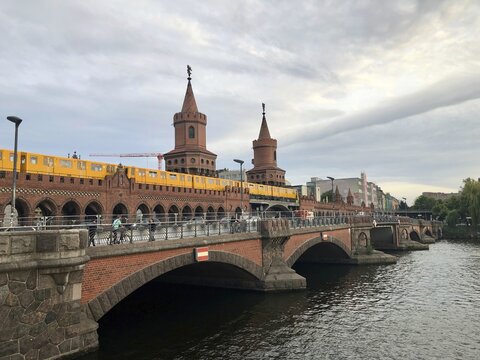 Yellow U-Bahn on Oberbaum bridge over the Spree river, Berlin, Germany