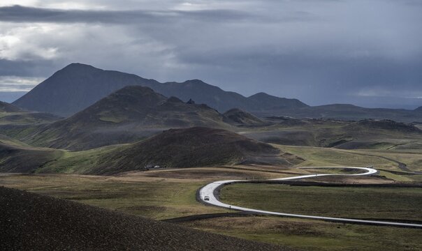 Road with bend runs through volcanic landscape, Myvatn, Northern Iceland, Iceland