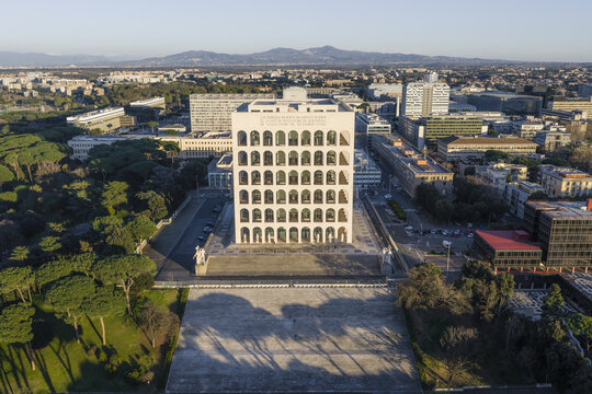 Rome, Italy - 21 February 2026: Aerial view of the Palazzo della Civilt&Atilde;&nbsp; Italiana rising majestically, its stark white arches contrasting against the urban landscape and distant mountains.