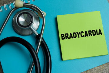 Concept of bradycardia write on sticky notes isolated on Wooden Table.