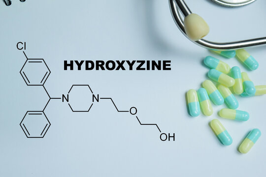 Concept of hydroxyzine antihistamine medication write on book isolated on Wooden Table. For allergy relief, sedative effect and anxiety treatment