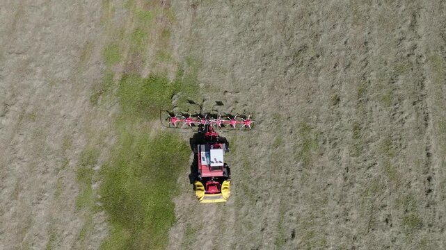Aerial view on hay tedder in action