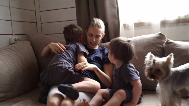 Family love endures. Daily shared love and resilience. Embracing each morning amidst chaotic family moments. Parents and children exchange affectionate gestures with loyal pet closeby