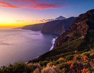 Fototapeta premium Coastal Sunset Panorama - Majestic Mountains and Ocean View.